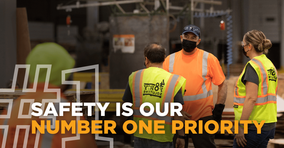 Safety Is Our Number One Priority with employees in safety gear